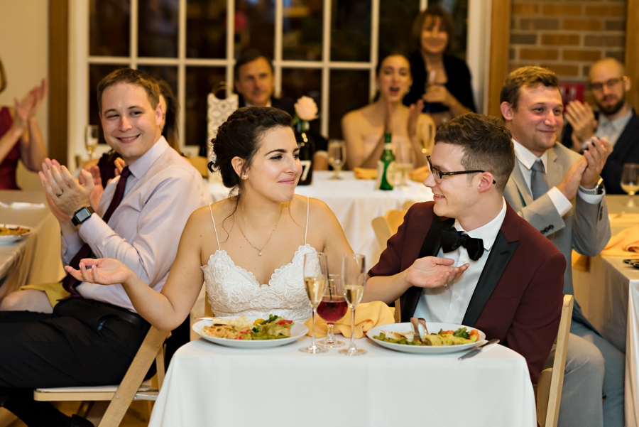 A bride and groom at the sweetheart table during the reception.